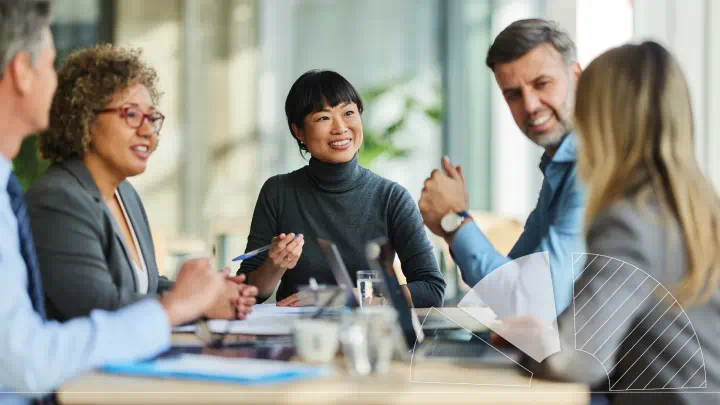 A group of people sitting around a table talking.