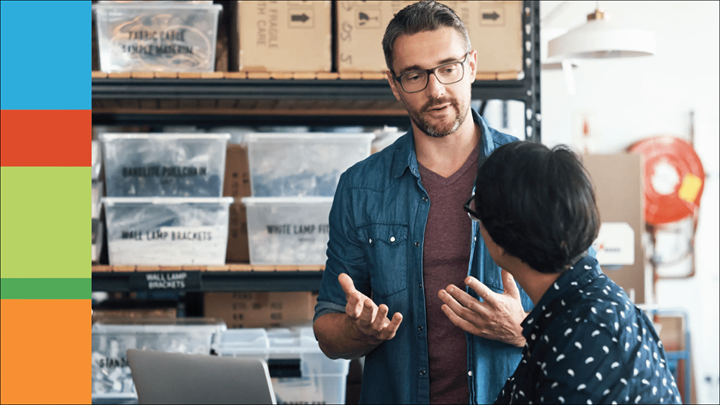 Business owner speaking with employee in supply room